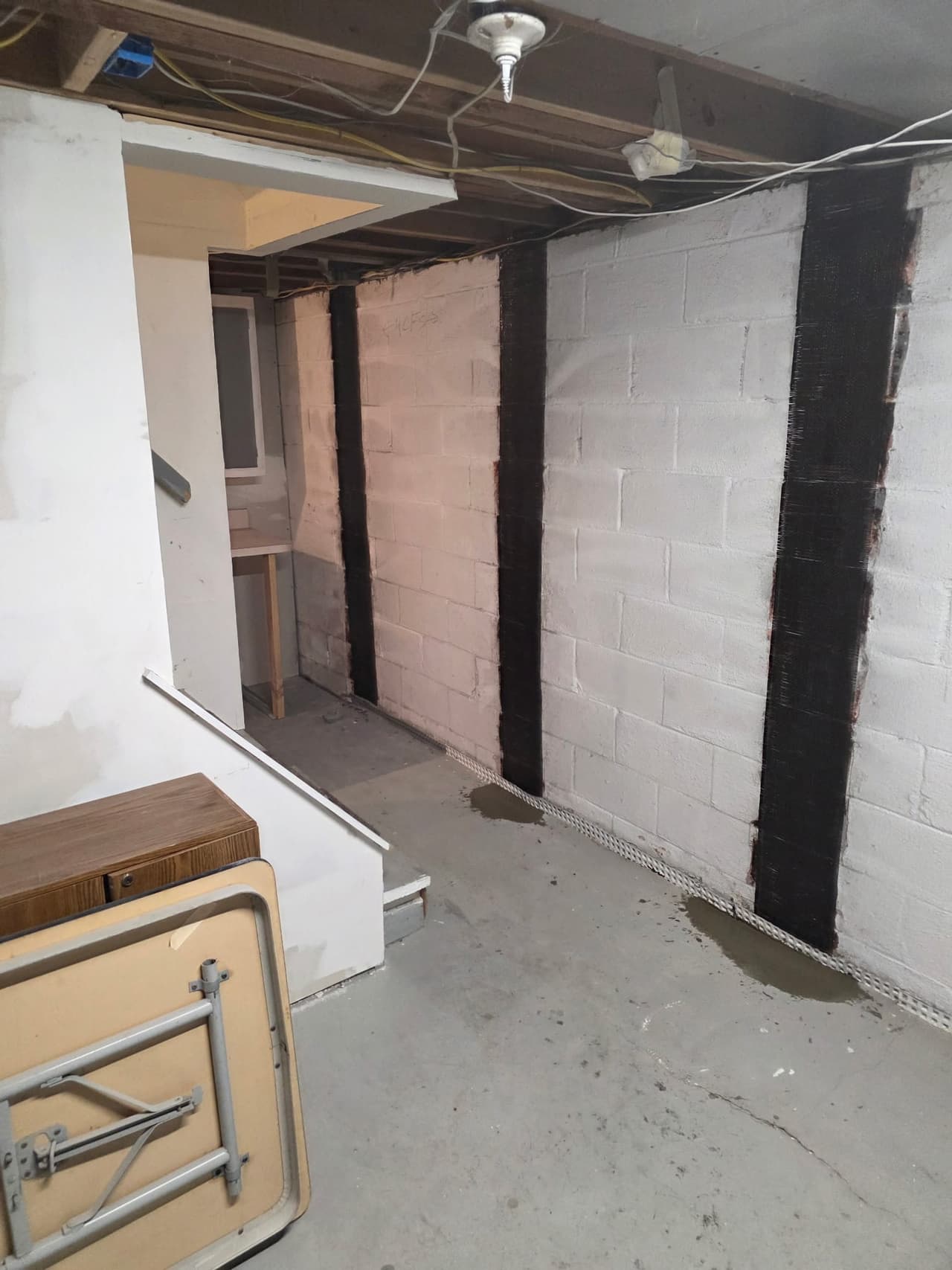 Basement wall reinforcement and drainage channel installed by Sunshine Waterproofing